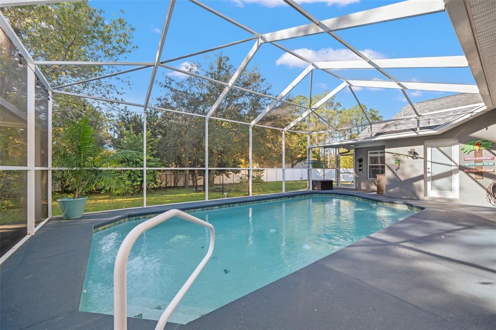 11180 Flock Avenue Weeki Wachee, FL 34613 - Photo 52 of 83 a view of a swimming pool with a porch