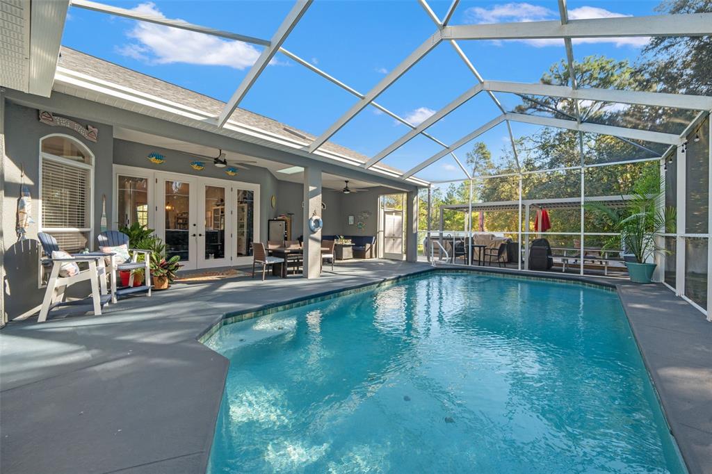 11180 Flock Avenue Weeki Wachee, FL 34613 - Photo 55 of 83 a view of a swimming pool with outdoor seating