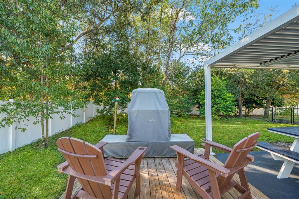 11180 Flock Avenue Weeki Wachee, FL 34613 - Photo 57 of 83 a view of a table and chairs in backyard of the house