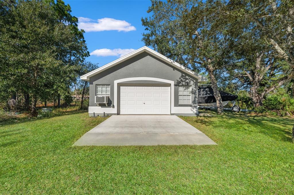 11180 Flock Avenue Weeki Wachee, FL 34613 - Photo 71 of 83 a front view of a house with yard and green space