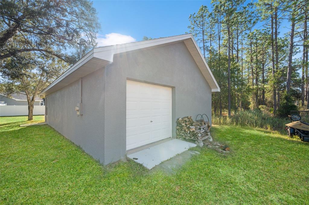 11180 Flock Avenue Weeki Wachee, FL 34613 - Photo 72 of 83 a backyard of a house with outdoor seating and trees