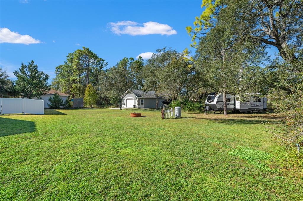 11180 Flock Avenue Weeki Wachee, FL 34613 - Photo 76 of 83 a house with green field