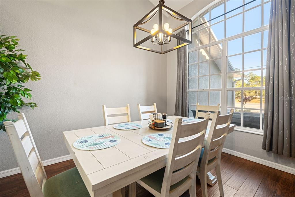 11180 Flock Avenue Weeki Wachee, FL 34613 - Photo 8 of 83 a view of a dining room with furniture window and wooden floor