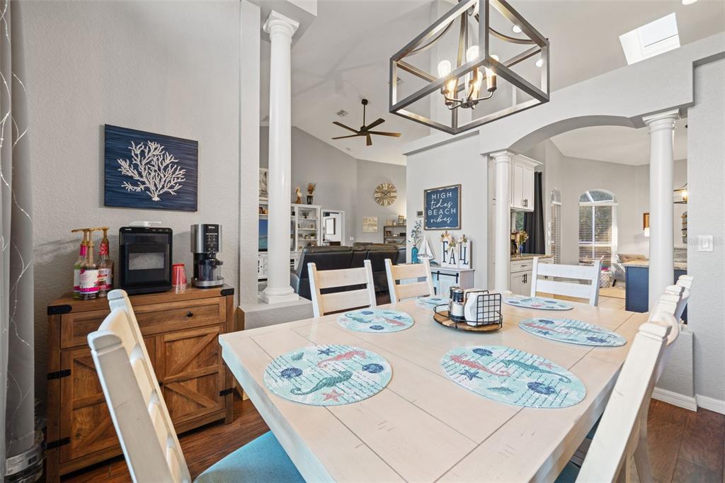 11180 Flock Avenue Weeki Wachee, FL 34613 - Photo 10 of 83 a view of a dining room with furniture a chandelier and wooden floor