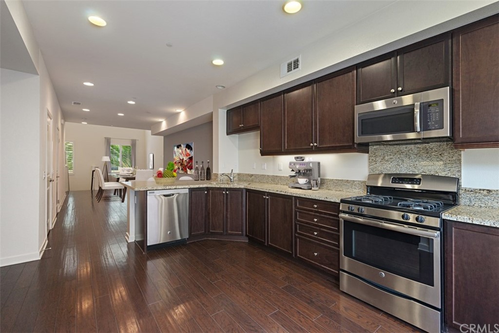 a kitchen with a sink stove and microwave