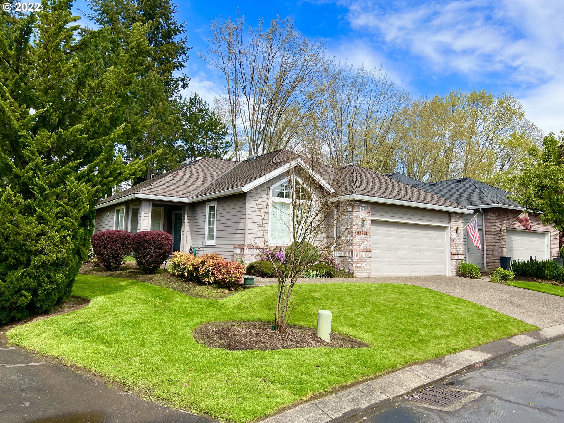 32504 Southwest Riviera Lane Wilsonville, OR 97070 - Photo 1 of 30 a front view of a house with a yard and garage