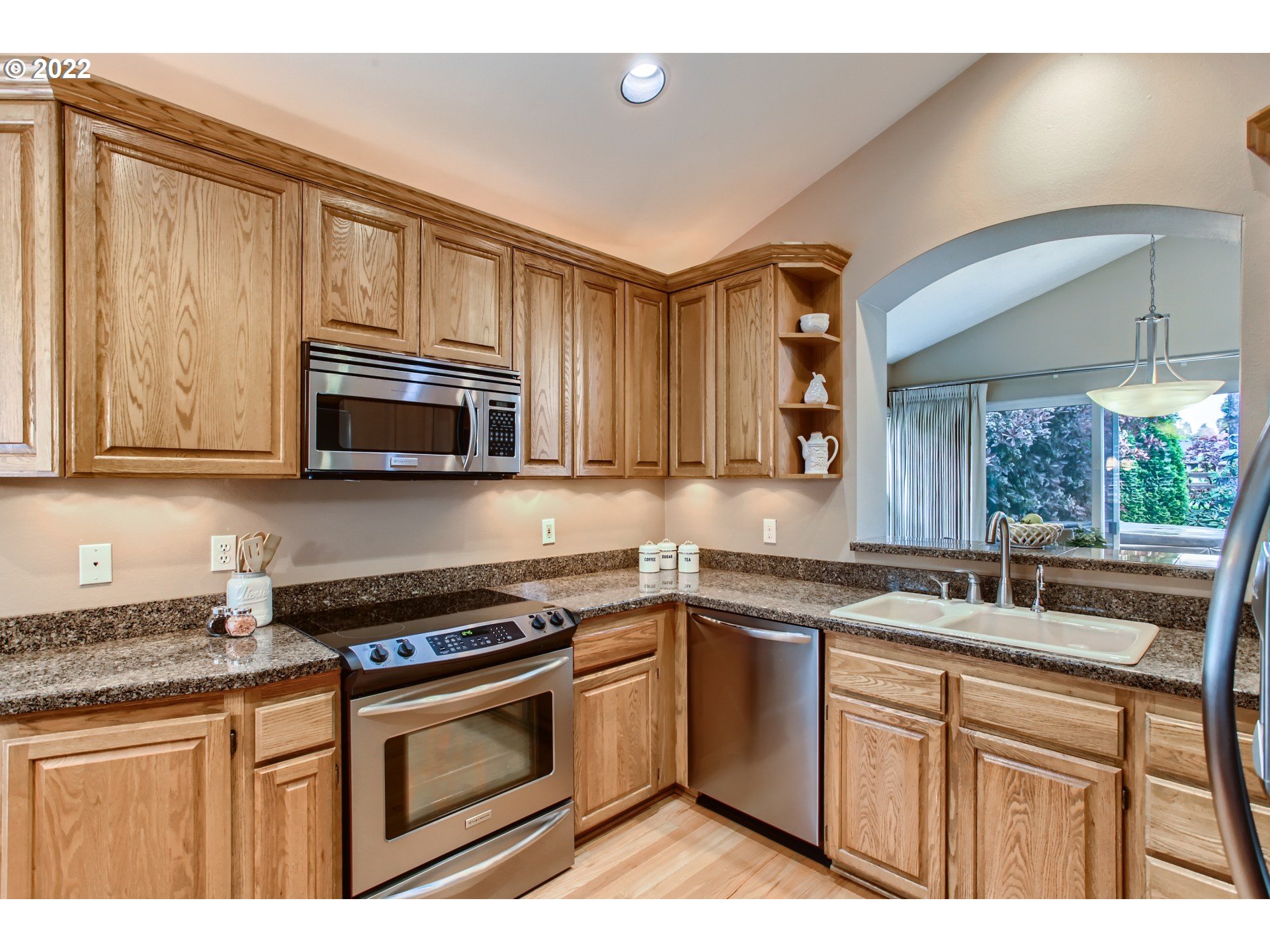 32504 Southwest Riviera Lane Wilsonville, OR 97070 - Photo 11 of 30 a kitchen with stainless steel appliances granite countertop a sink stove and microwave