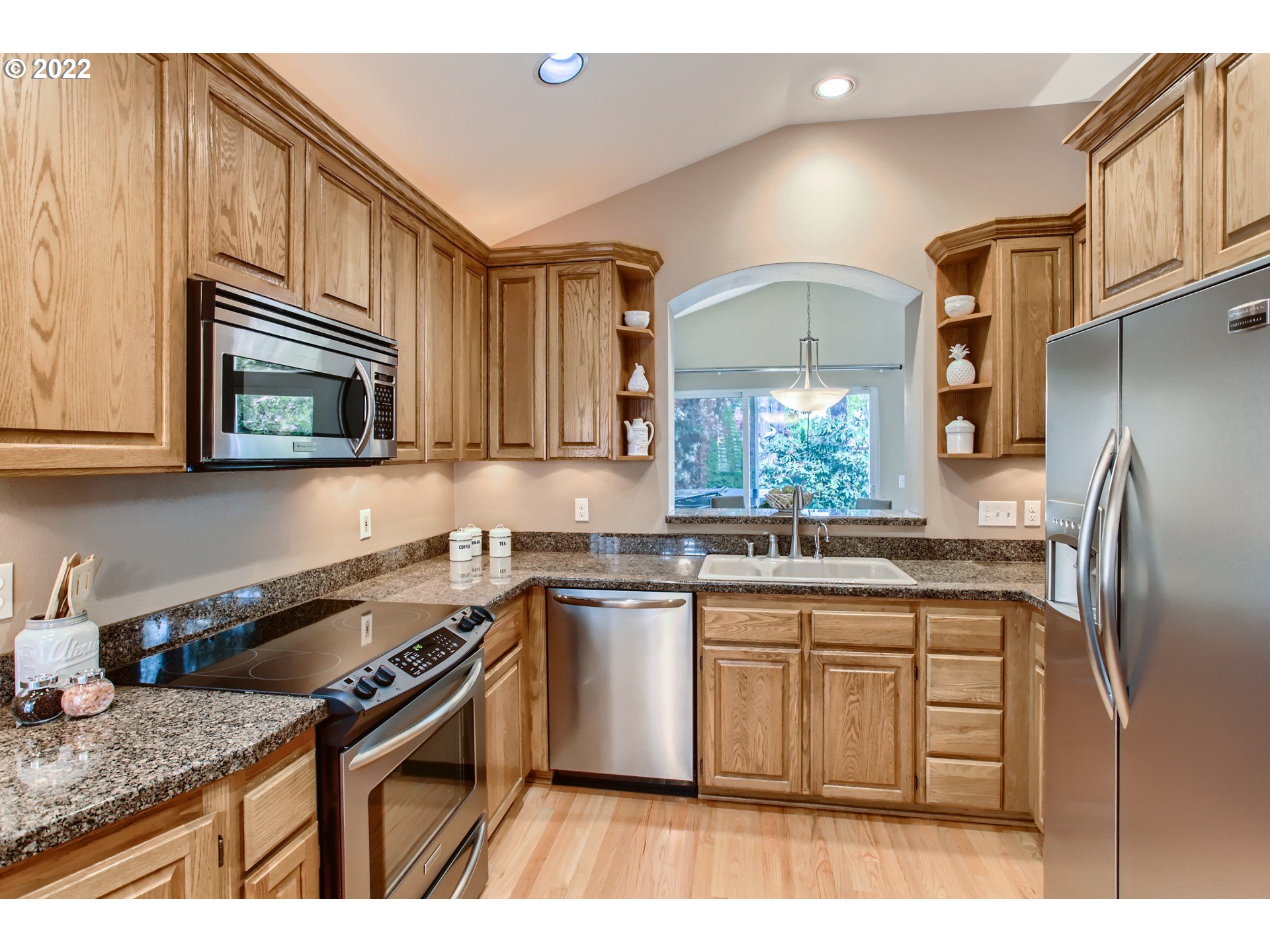 32504 Southwest Riviera Lane Wilsonville, OR 97070 - Photo 12 of 30 a kitchen with stainless steel appliances granite countertop a sink stove and refrigerator