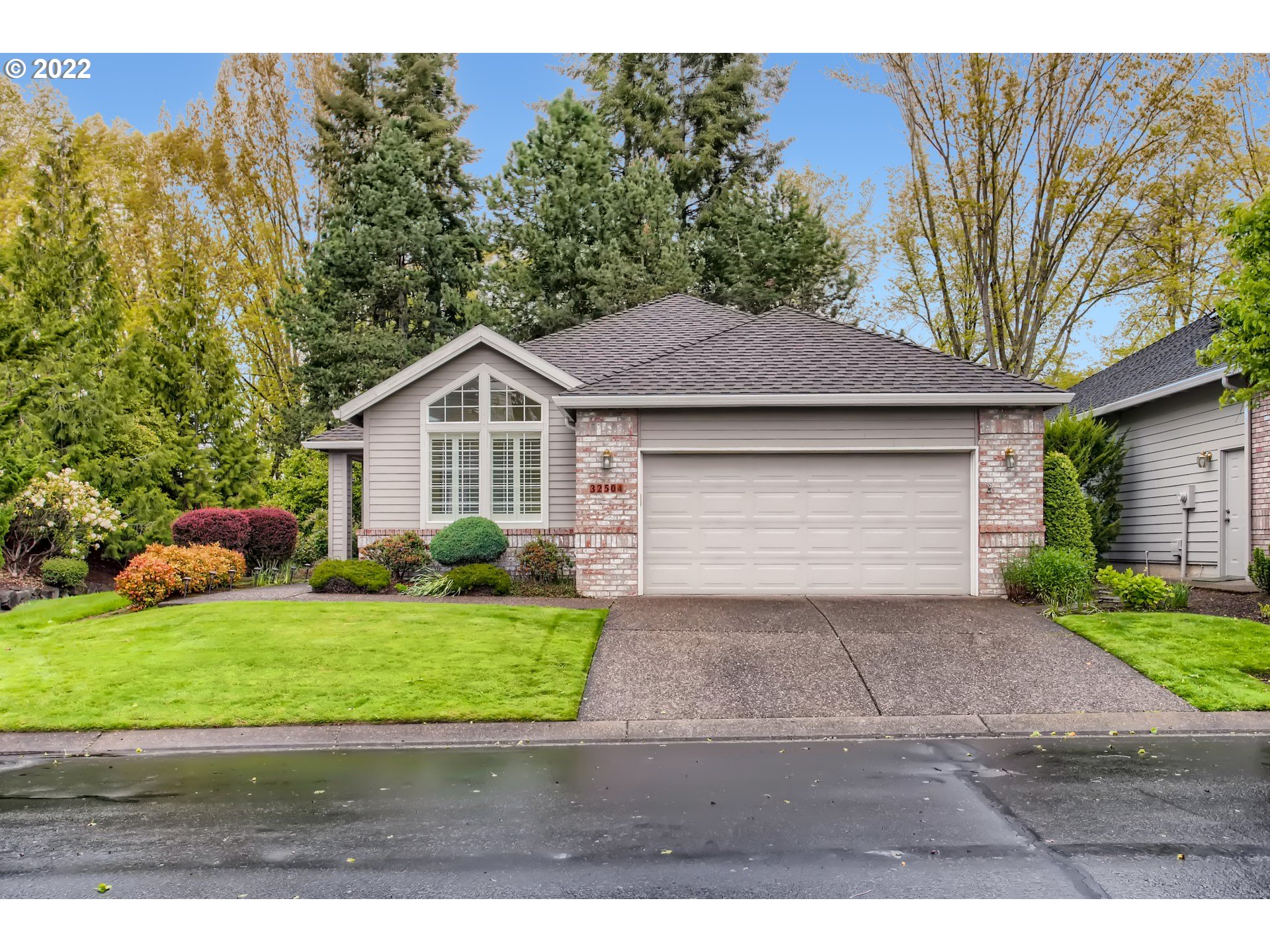 32504 Southwest Riviera Lane Wilsonville, OR 97070 - Photo 2 of 30 a front view of a house with a yard and garage
