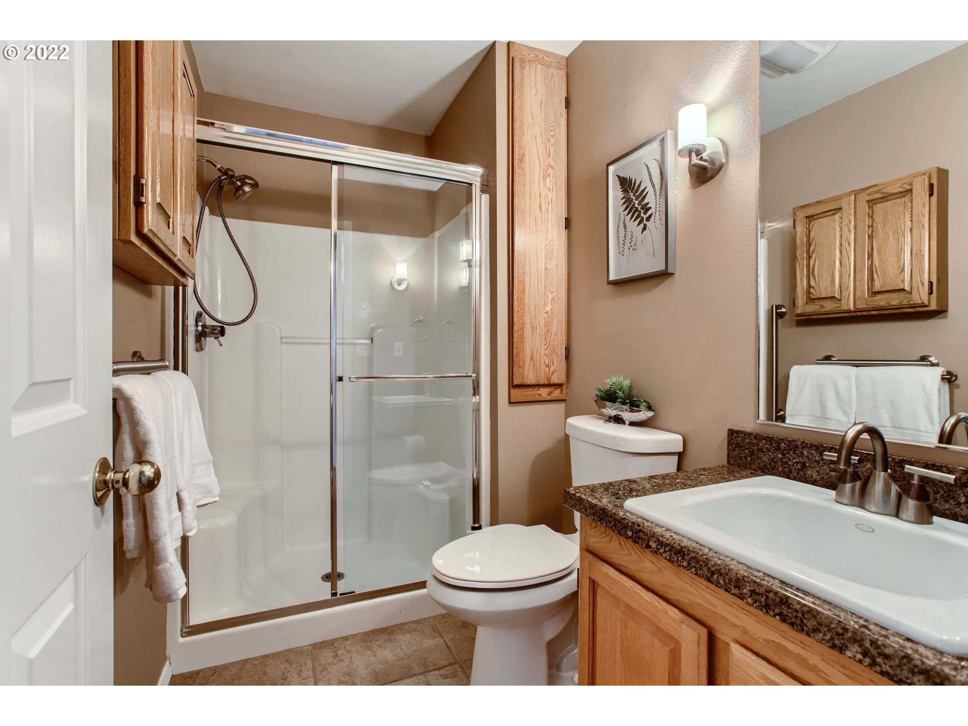32504 Southwest Riviera Lane Wilsonville, OR 97070 - Photo 23 of 30 a bathroom with a granite countertop sink toilet and shower
