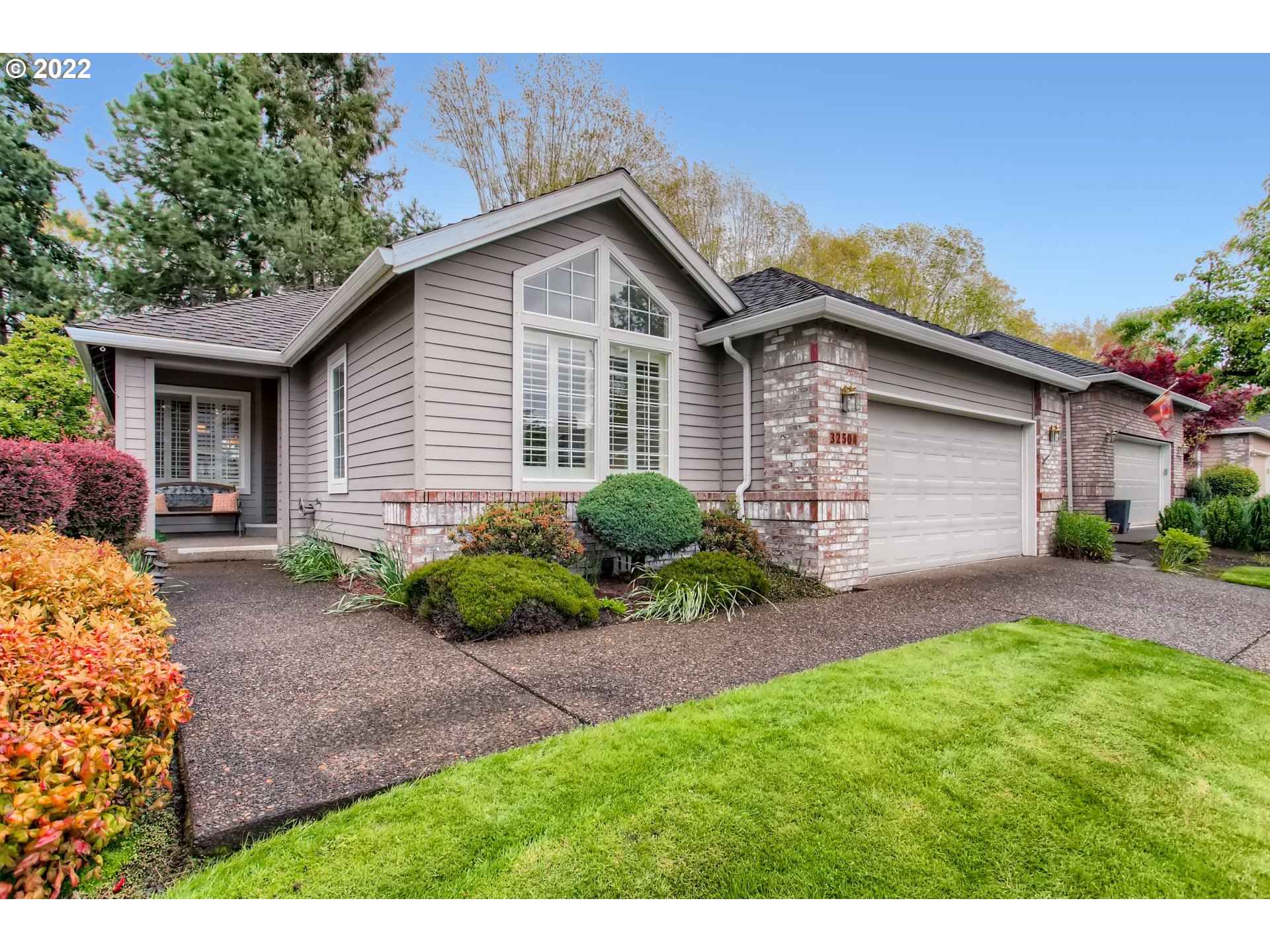 32504 Southwest Riviera Lane Wilsonville, OR 97070 - Photo 3 of 30 a front view of a house with a yard and garage
