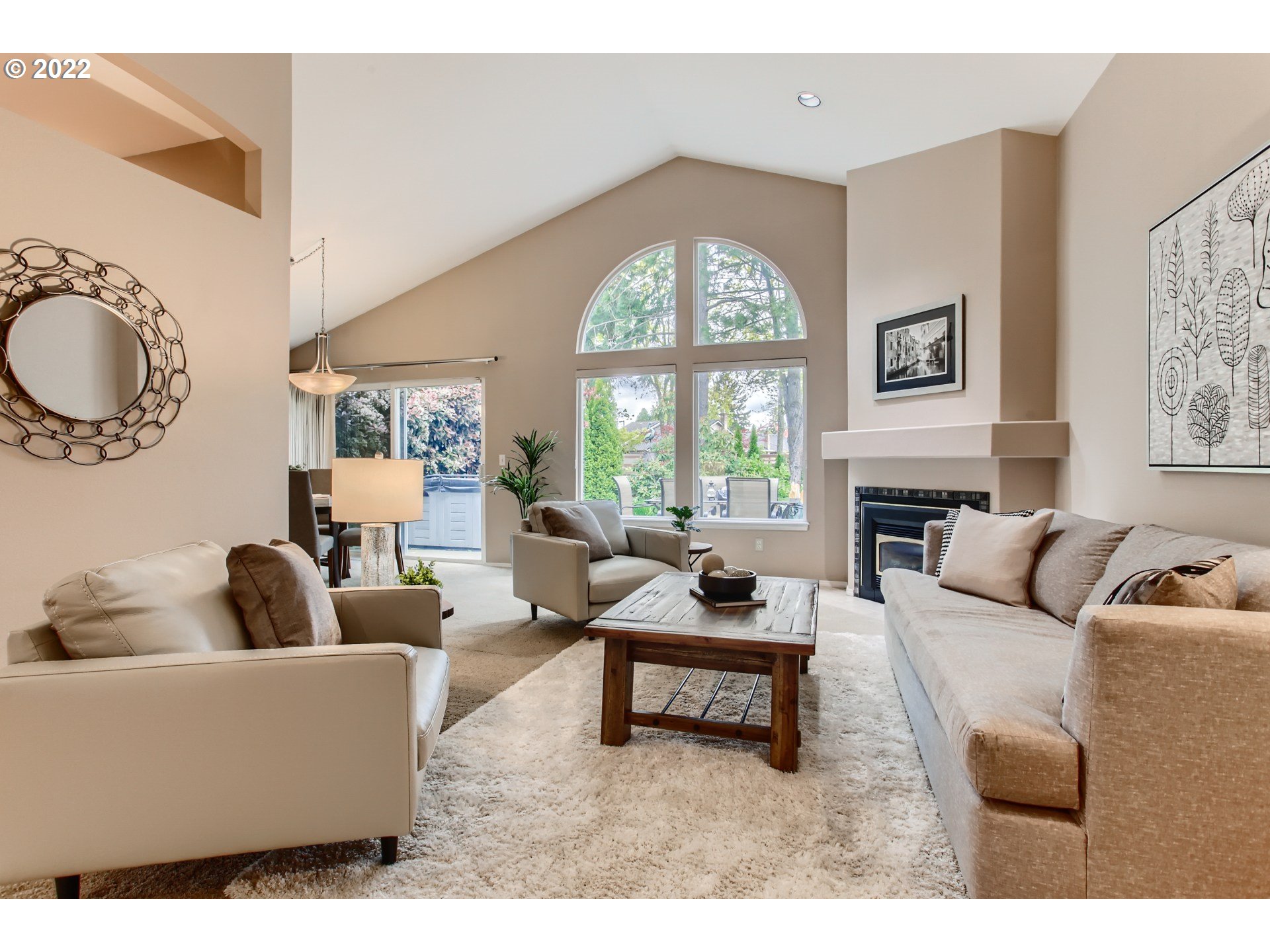 32504 Southwest Riviera Lane Wilsonville, OR 97070 - Photo 7 of 30 a living room with furniture a fireplace a large window and potted plants