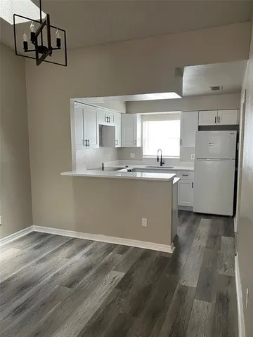 a kitchen with a sink stainless steel appliances and cabinets