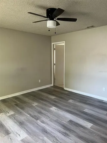 a view of a room with a ceiling fan