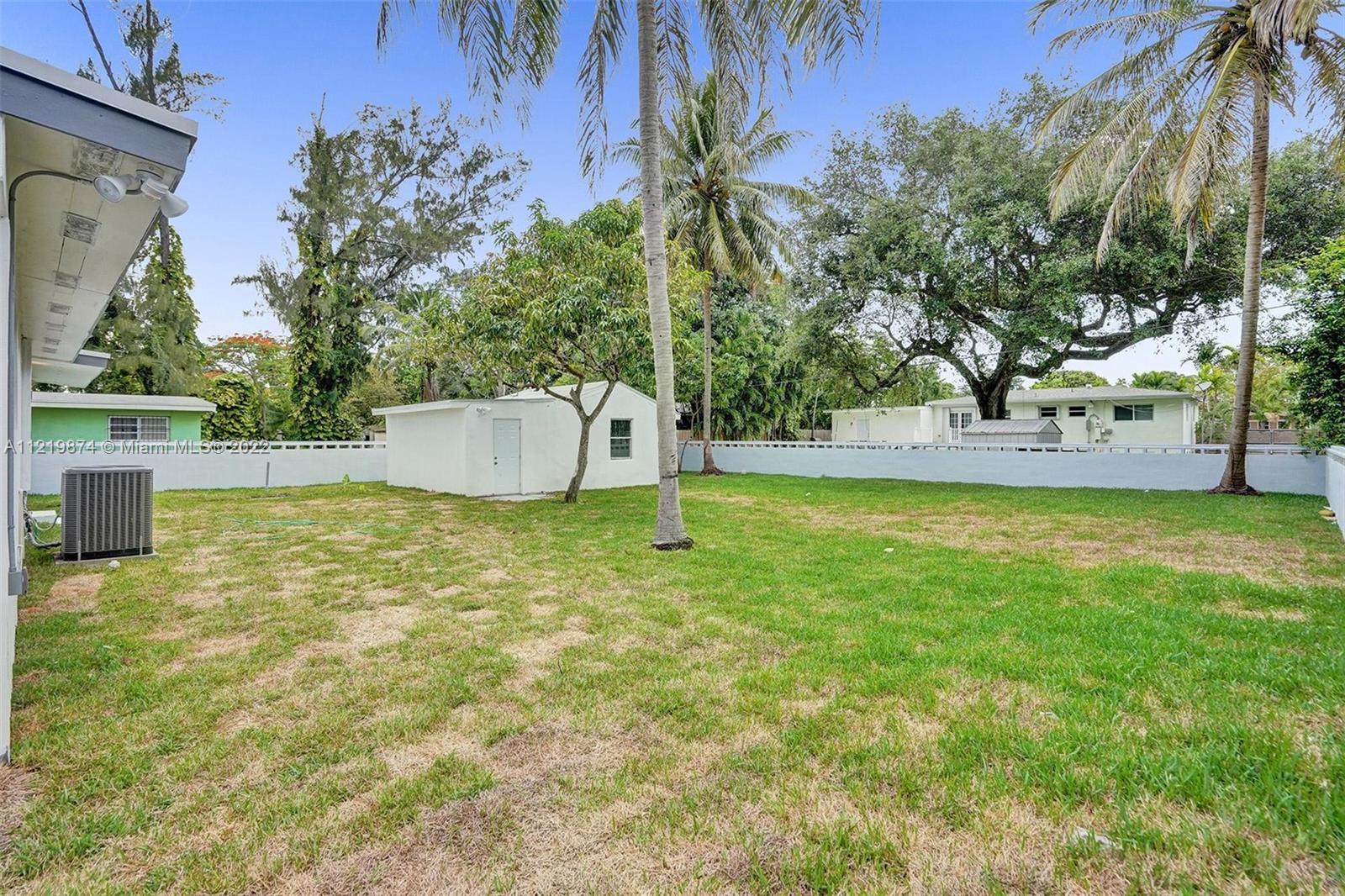 369 Northeast 158th Street Miami, FL 33162 - Photo 11 of 58 a backyard of a house with lots of green space