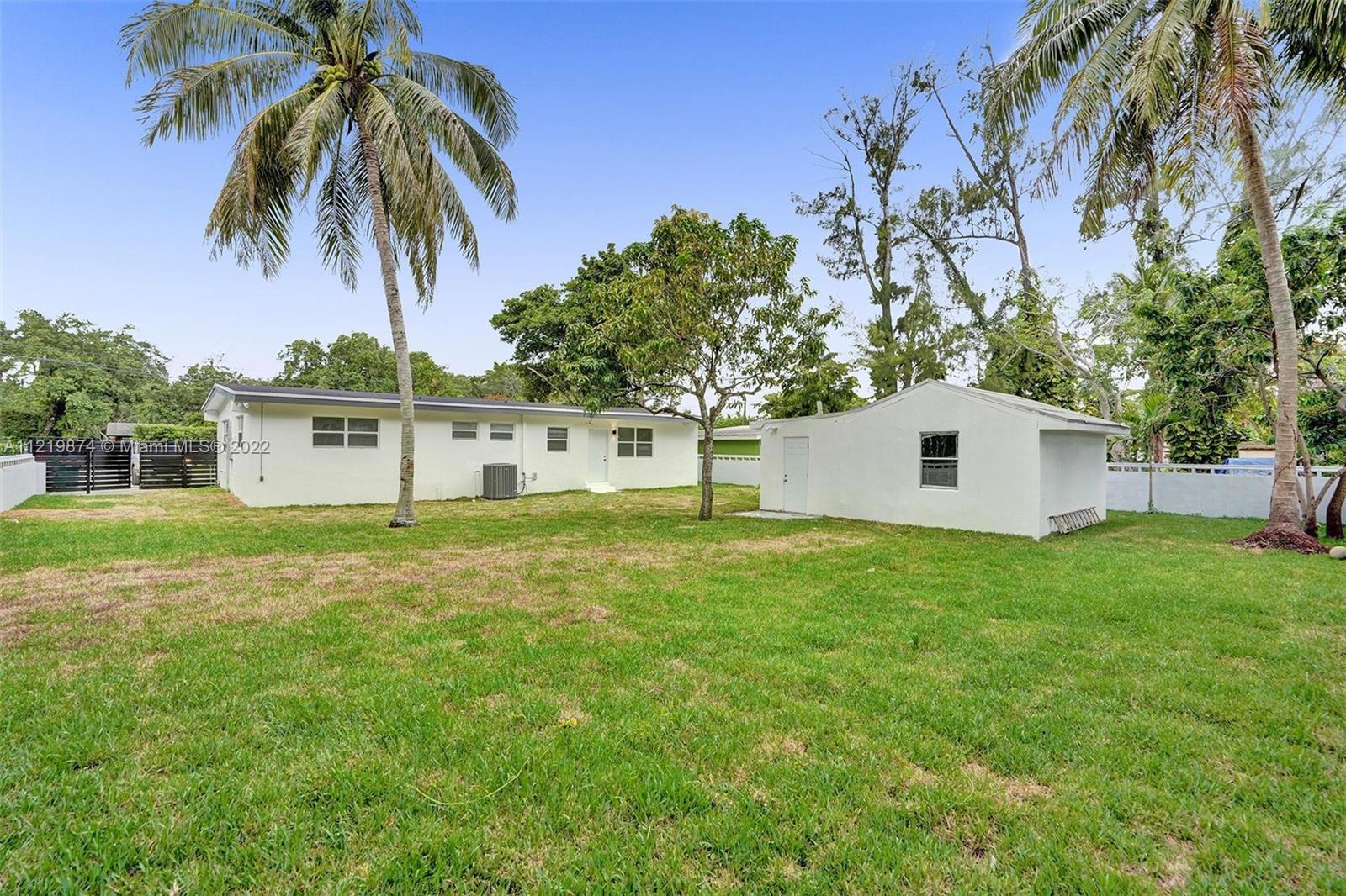 369 Northeast 158th Street Miami, FL 33162 - Photo 12 of 58 a view of a house with a backyard
