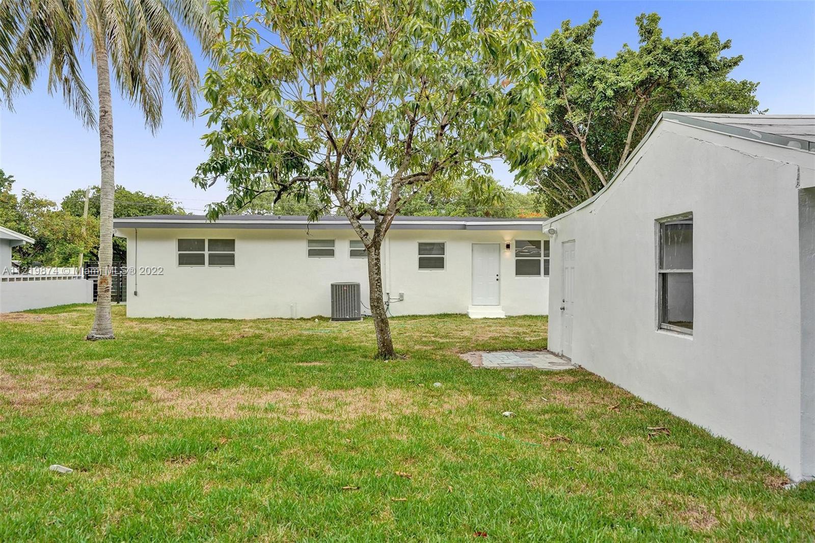 369 Northeast 158th Street Miami, FL 33162 - Photo 13 of 58 a view of a house with a backyard