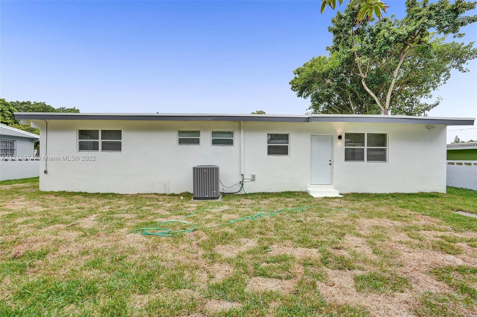 369 Northeast 158th Street Miami, FL 33162 - Photo 18 of 58 a view of a house with a backyard
