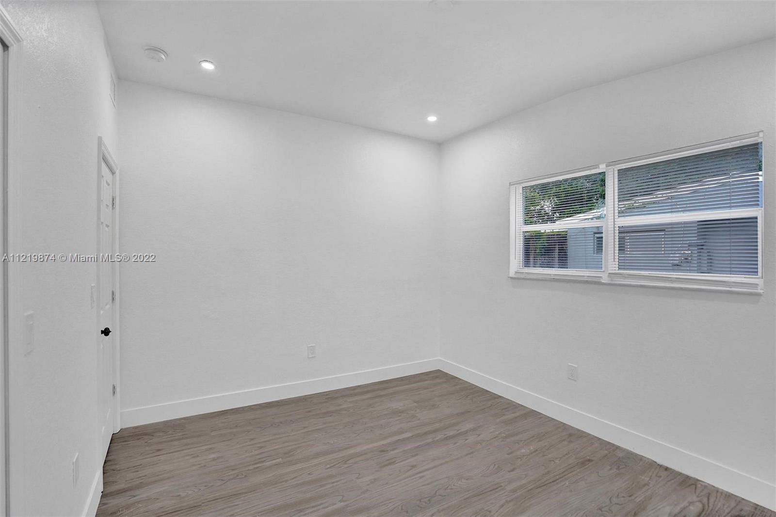 369 Northeast 158th Street Miami, FL 33162 - Photo 30 of 58 a view of empty room with wooden floor and fan