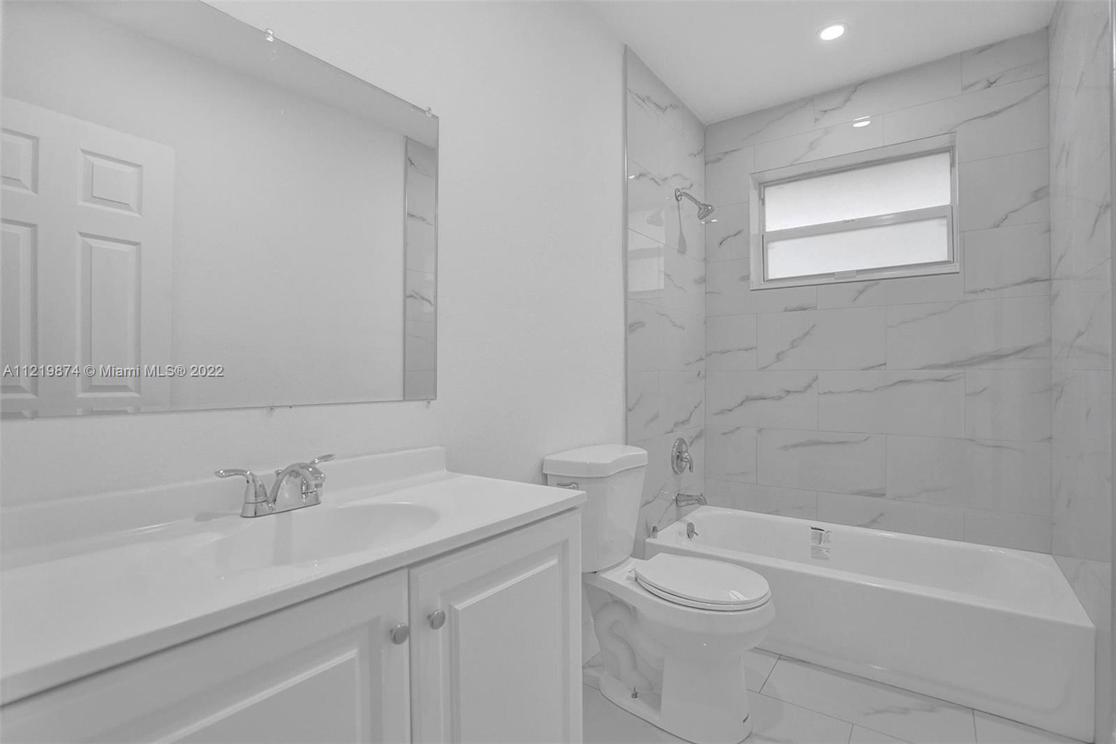 369 Northeast 158th Street Miami, FL 33162 - Photo 36 of 58 a bathroom with a sink a toilet and shower