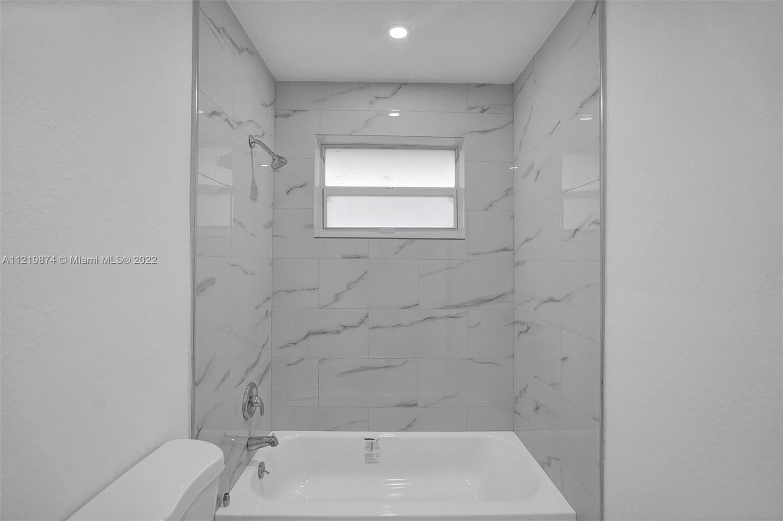 369 Northeast 158th Street Miami, FL 33162 - Photo 37 of 58 a bathroom with a toilet sink and bathtub