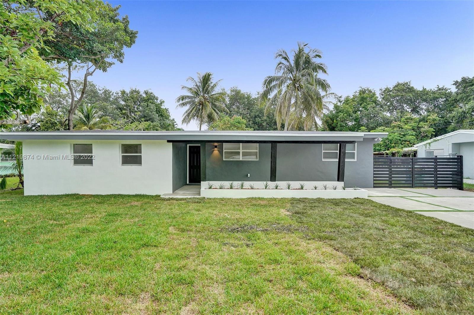 369 Northeast 158th Street Miami, FL 33162 - Photo 4 of 58 a view of a house with a yard and a tree