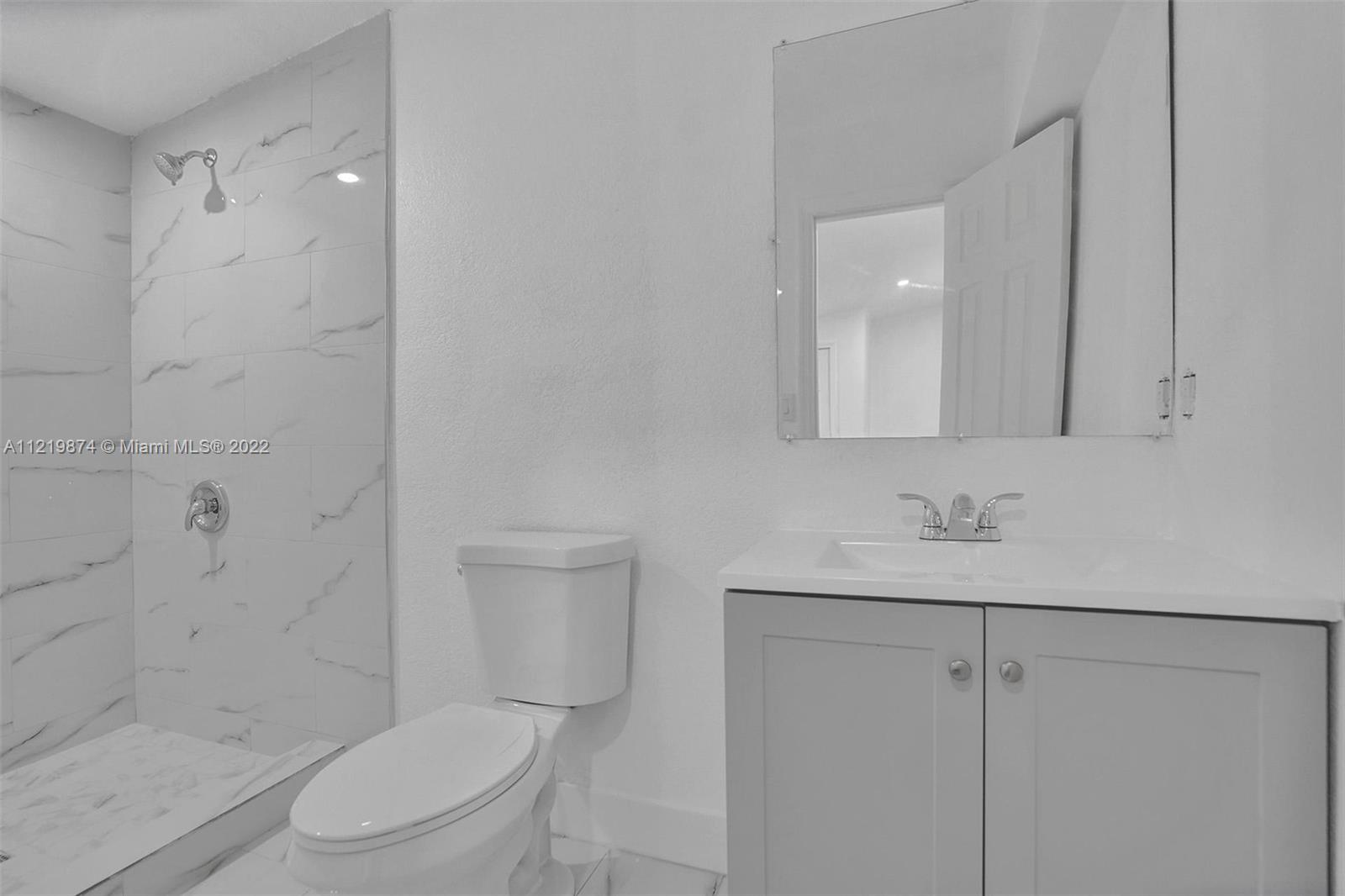 369 Northeast 158th Street Miami, FL 33162 - Photo 44 of 58 a bathroom with a toilet a sink and shower