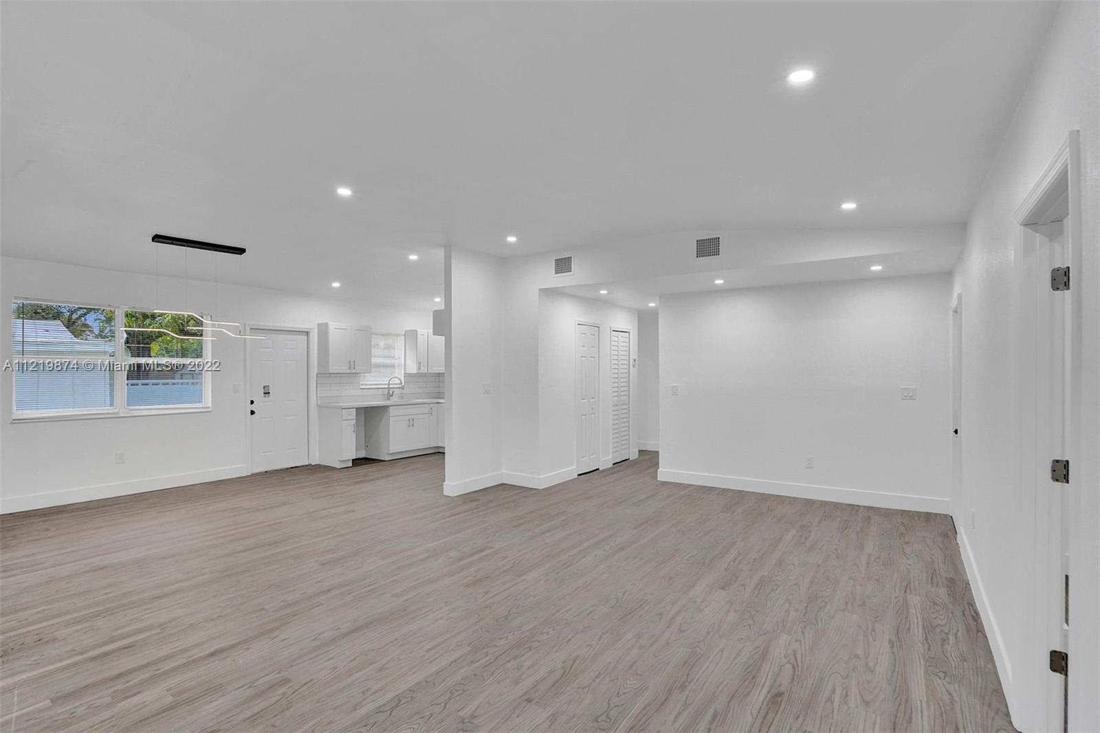 369 Northeast 158th Street Miami, FL 33162 - Photo 46 of 58 a view of a big room with wooden floors