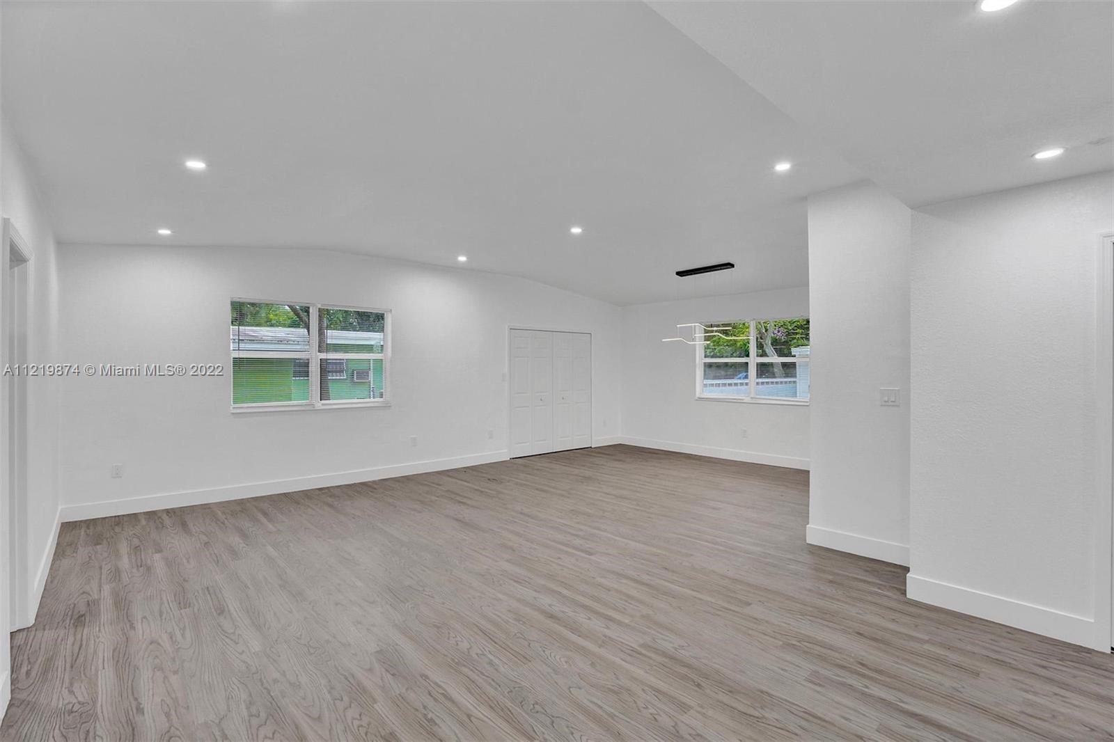 369 Northeast 158th Street Miami, FL 33162 - Photo 48 of 58 an empty room with wooden floor and windows