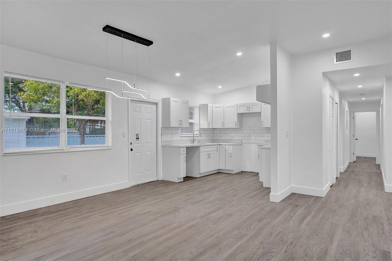 369 Northeast 158th Street Miami, FL 33162 - Photo 50 of 58 a view of kitchen with wooden floor and electronic appliances
