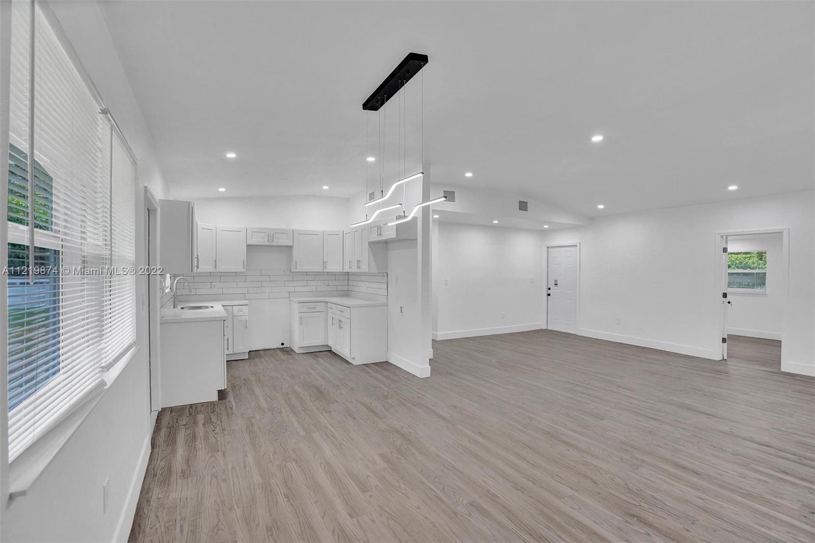 369 Northeast 158th Street Miami, FL 33162 - Photo 56 of 58 a view of a kitchen with a sink and a refrigerator