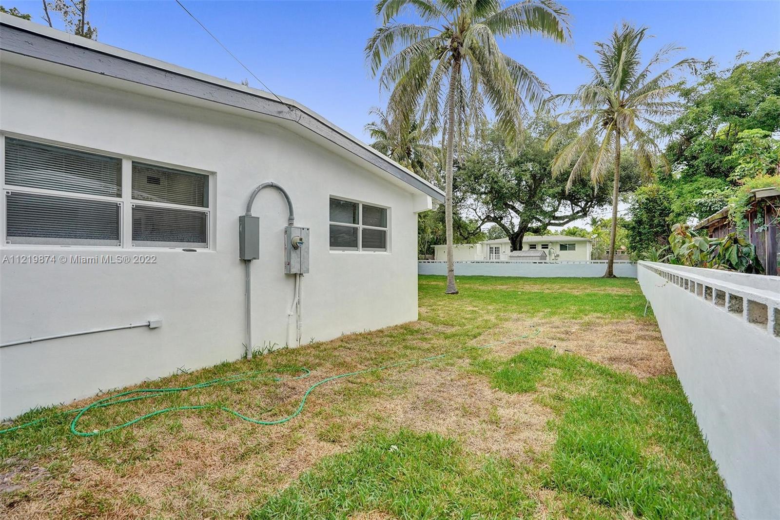 369 Northeast 158th Street Miami, FL 33162 - Photo 8 of 58 a view of a house with a yard