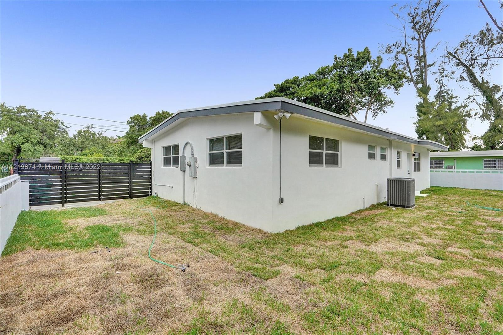 369 Northeast 158th Street Miami, FL 33162 - Photo 9 of 58 a view of a house with a backyard