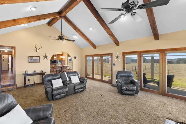 a living room with furniture and a floor to ceiling window