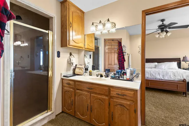 a en suite bathroom with a sink double vanity and a mirror