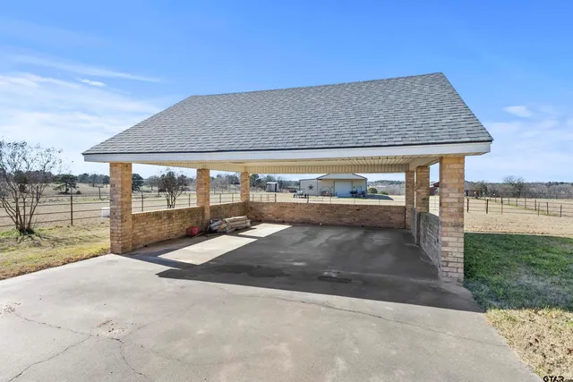 a view of a swimming pool with chair and table