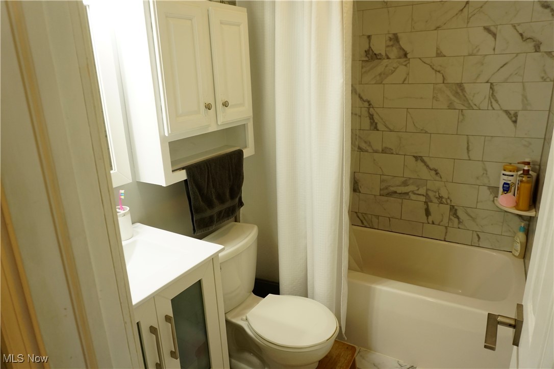 236 South Hickin Street Rittman, OH 44270 - Photo 20 of 27 Full bathroom with vanity, shower / tub combo with curtain, and toilet