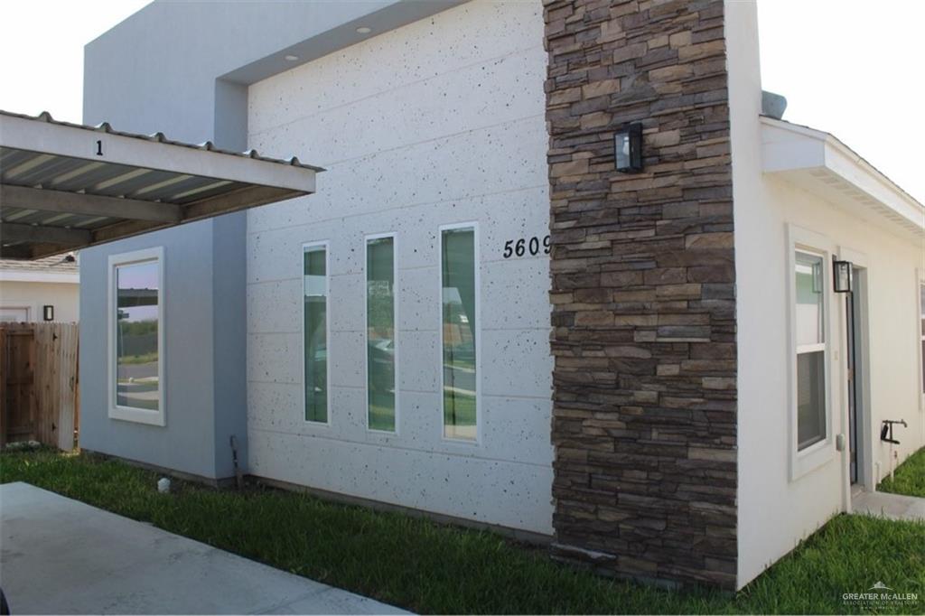 5609 Ozark Avenue, Unit 1 Mission, TX 78573 - Photo 1 of 8 a front view of a house with a yard