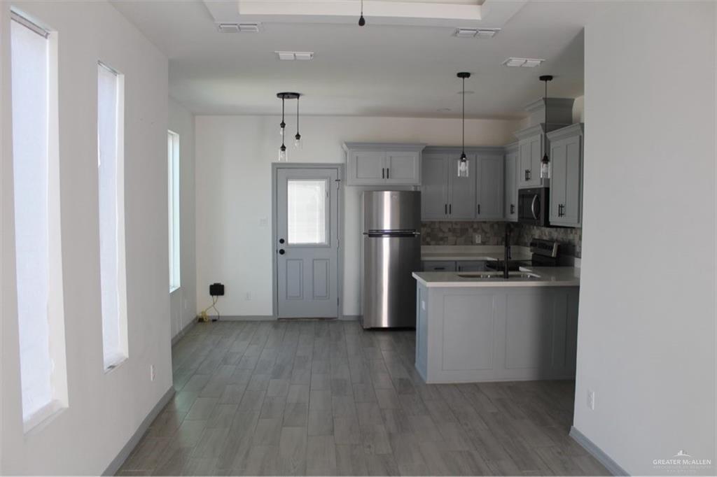 5609 Ozark Avenue, Unit 1 Mission, TX 78573 - Photo 4 of 8 a kitchen with stainless steel appliances a refrigerator and a stove top oven