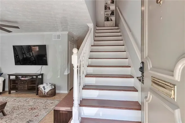 a view of entryway livingroom and hall with wooden floor