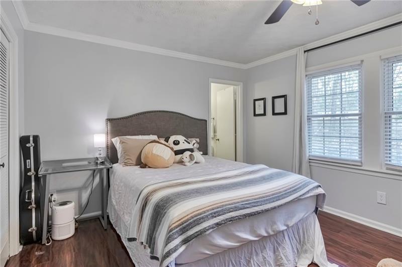 8 Arpege Way Northwest Atlanta, GA 30327 - Photo 12 of 36 a bedroom with a bed and a chandelier