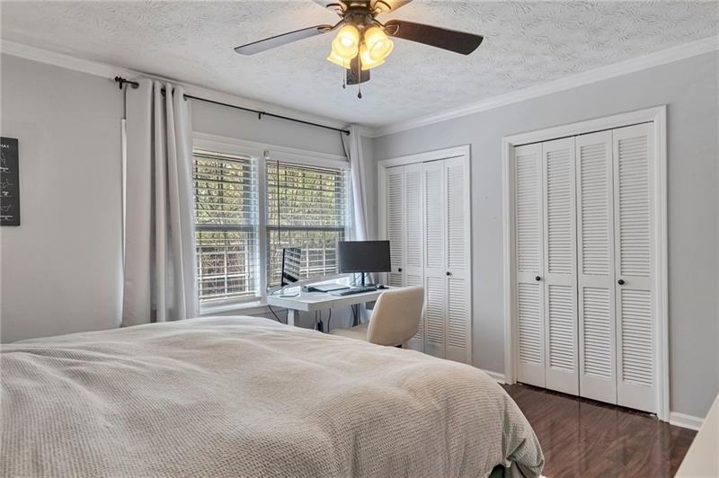 8 Arpege Way Northwest Atlanta, GA 30327 - Photo 14 of 36 a bedroom with a bed and a chandelier