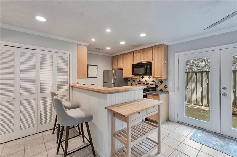 8 Arpege Way Northwest Atlanta, GA 30327 - Photo 2 of 36 a kitchen with a refrigerator and a sink