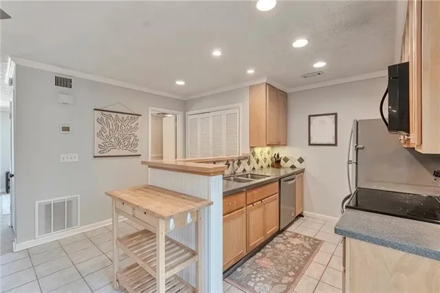 a kitchen with stainless steel appliances granite countertop a stove and a sink
