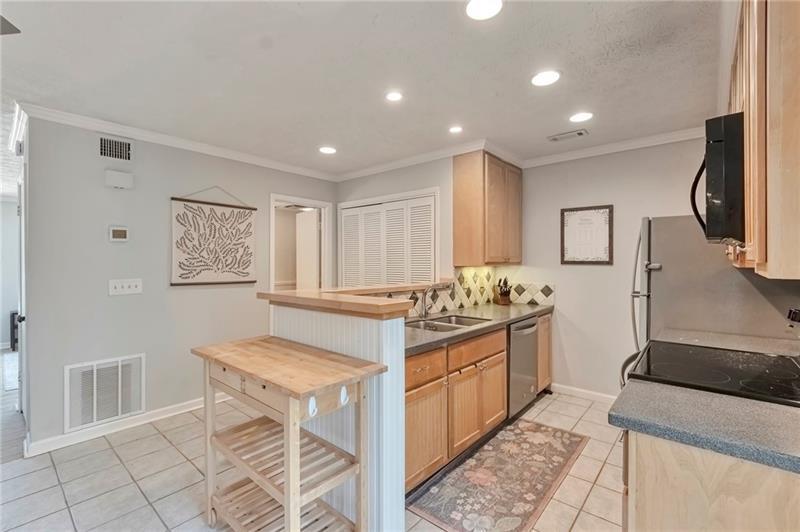 8 Arpege Way Northwest Atlanta, GA 30327 - Photo 4 of 36 a kitchen with stainless steel appliances granite countertop a stove and a sink
