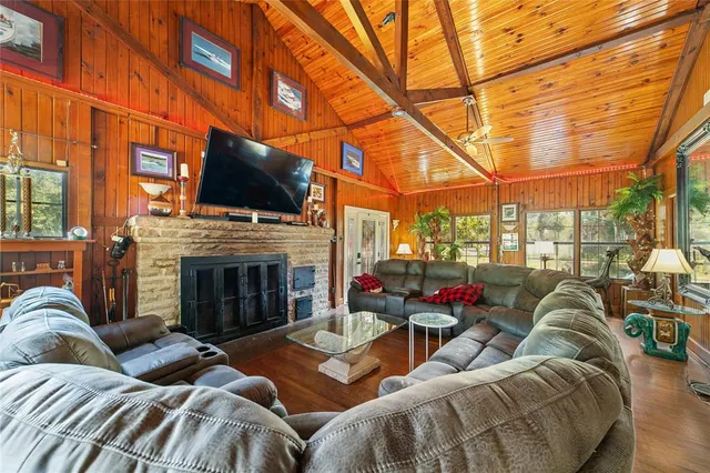 a living room with furniture fireplace and flat screen tv
