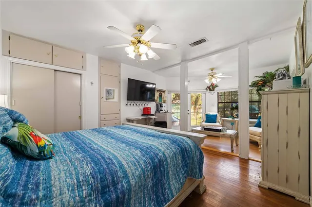 a bedroom with a bed and a chandelier