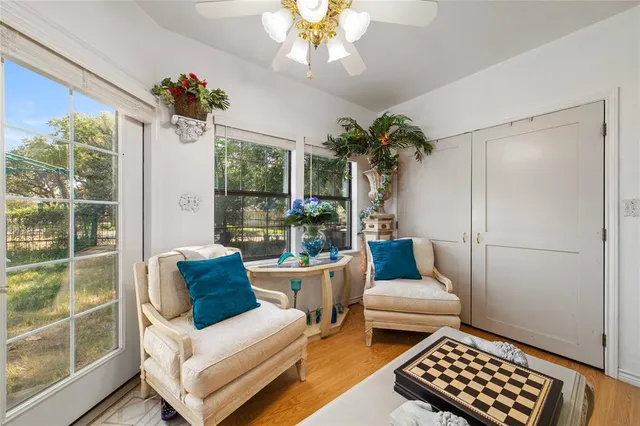 a bedroom with furniture and a large window