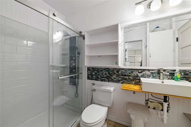 a bedroom with a bed and a large window with outer view