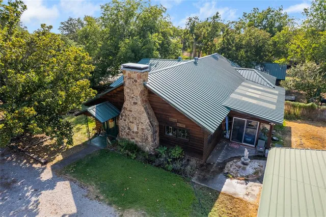 a view of a patio with table and chairs and potted plants